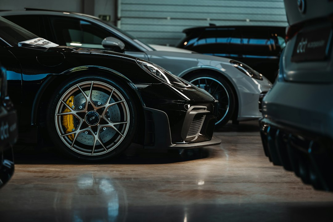 Luxury sports cars displayed in modern automotive showroom with professional service environment