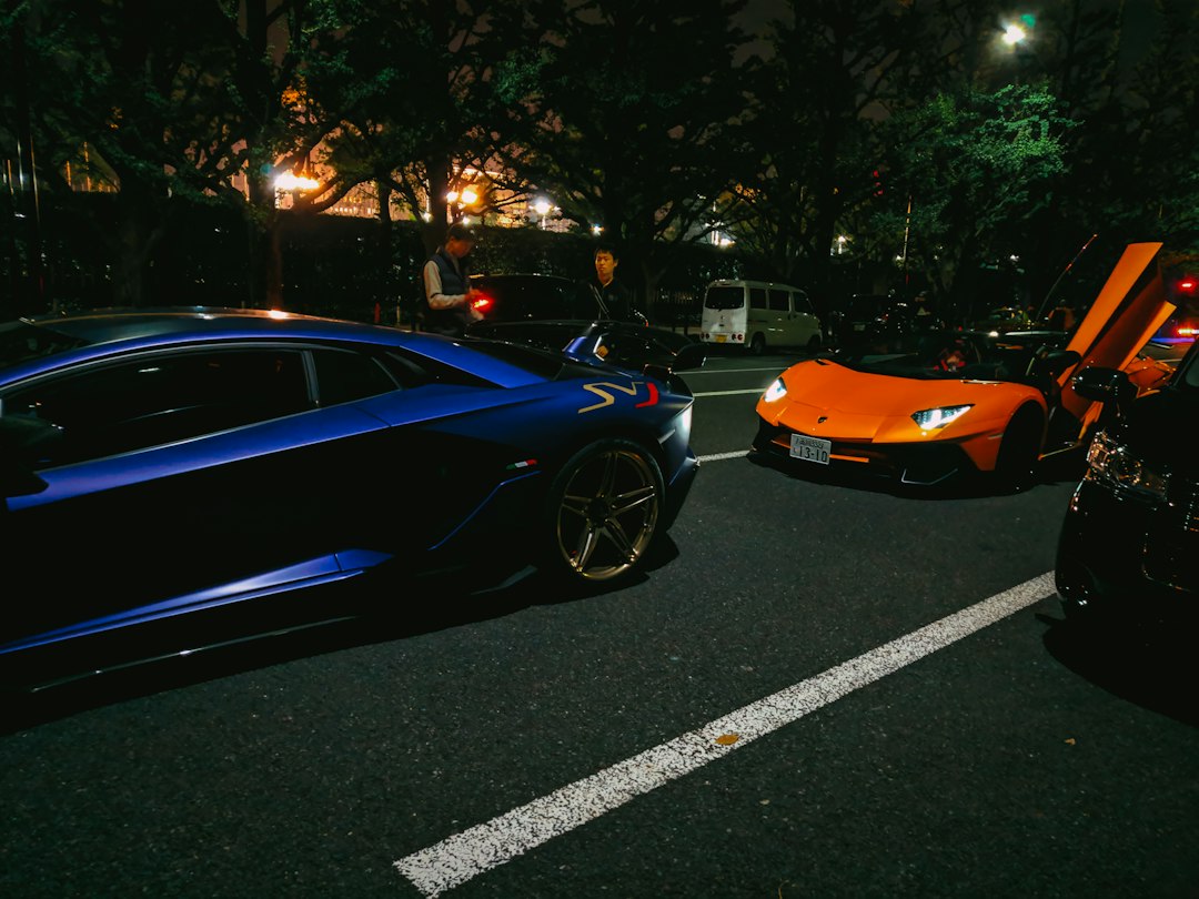 Multiple luxury sports cars parked professionally in a service showroom
